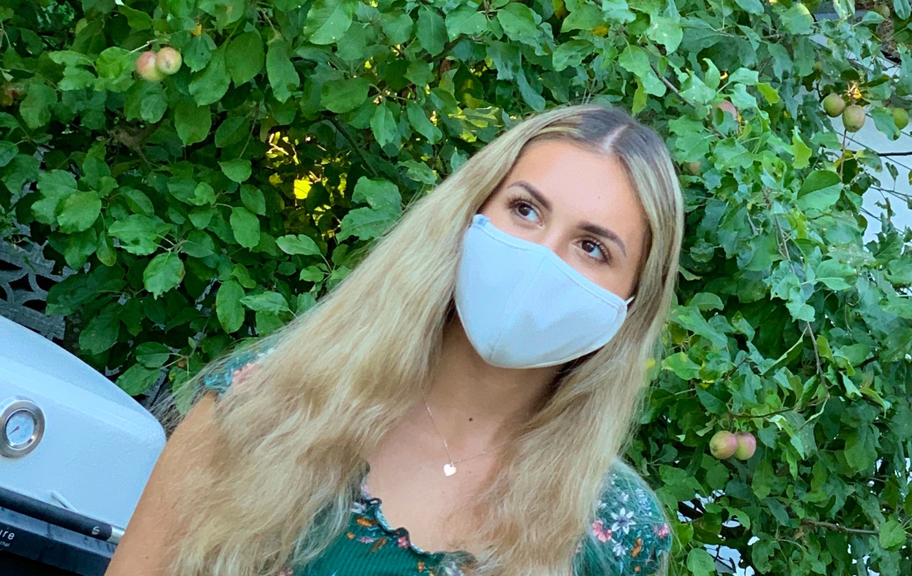 Woman wearing a facemask for blog explaining facemask fabric efficacy and safety.